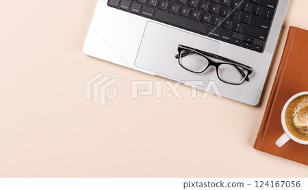 A clean and minimal desk setup featuring a laptop and a coffee cup A clean and minimal desk setup featuring a laptop and a coffee cup 124167056