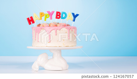 A festive birthday cake topped with colorful candles A festive birthday cake topped with colorful candles 124167057