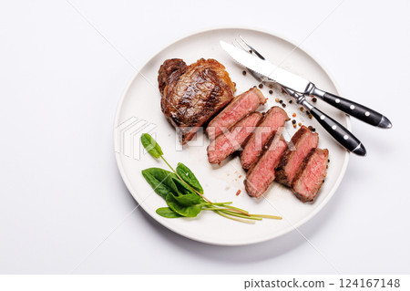A perfectly cooked sliced striploin steak with a juicy, tender texture 124167148