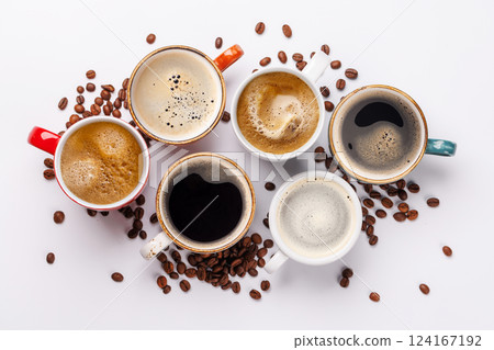 A steaming cups of freshly brewed coffee surrounded by rich, aromatic roasted coffee beans 124167192