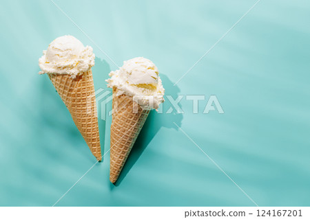 A refreshing ice cream cones set against a vibrant background A refreshing ice cream cones set against a vibrant background 124167201