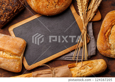 An assortment of freshly baked bread displayed on a table An assortment of freshly baked bread displayed on a table 124167205