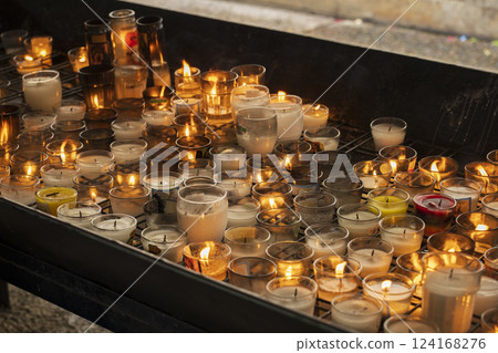 Nice collection of lit prayer candles 124168276
