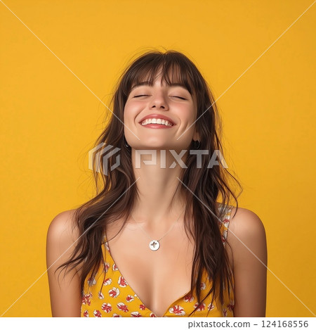Portrait of a happy woman on an orange studio background 124168556