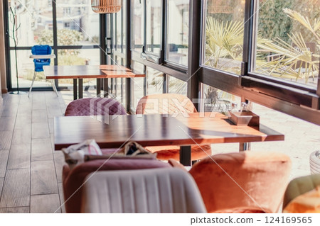 A restaurant with a lot of tables and chairs A restaurant with a lot of tables and chairs 124169565