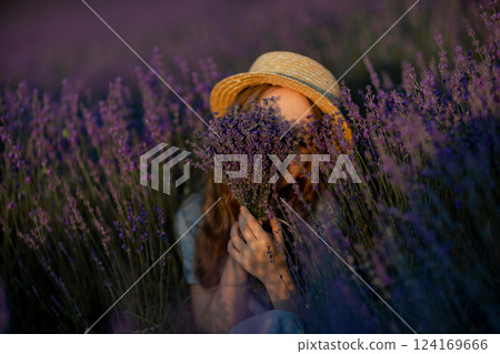 Lavender Field Woman: Woman holds bouquet, hides face during summer in lavender field. 124169666