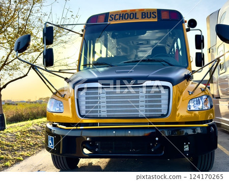 Yellow school bus in rural area 124170265