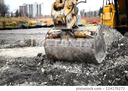 yellow excavators on construction site excavator bucket close up yellow excavators on construction site excavator bucket close up 124170272