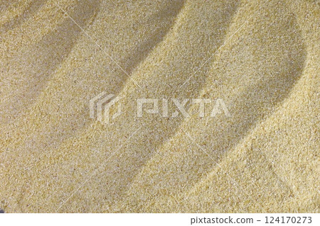 Fine golden sand in the form of waves on the beach Fine golden sand in the form of waves on the beach 124170273