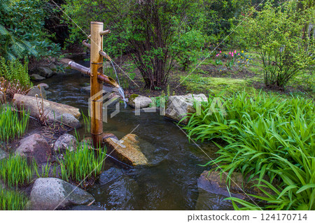 Water source from bamboo trunk in Japanese garden in April Water source from bamboo trunk in Japanese garden in April 124170714