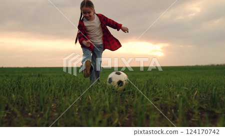 child kid baby girl run across green lawn sunset, kicking soccer ball, playing football field, childhood dream happy kid, spontaneous soccer game, green grass field, recreational soccer fun, casual 124170742