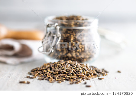 Milk thistle seeds on kitchen table. 124170820