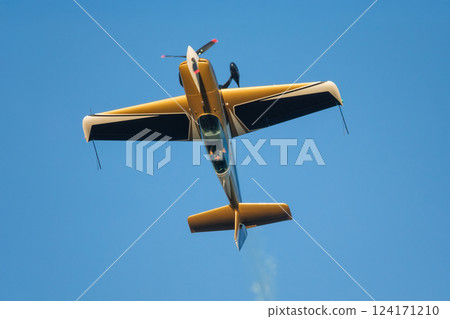 Stunt aerobatic plane performing stunts in air Stunt aerobatic plane performing stunts in air 124171210