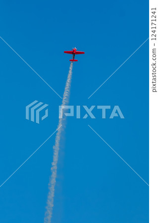 Stunt aerobatic plane performing stunts in air 124171241