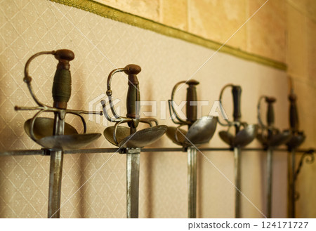 Set of Medieval Swords Exposed with a White Background of Castle wall 124171727