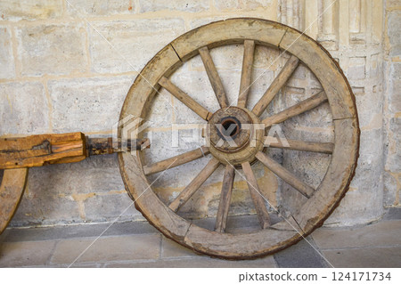Antique wooden carriage wheel exposed on the street Antique wooden carriage wheel exposed on the street 124171734
