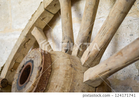 Antique wooden carriage wheel exposed on the street 124171741