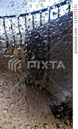 Rainy Window View at Airport Blurred Background with Water Droplets 124172141