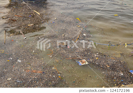 Polluted Water with Floating Trash Near Shore Environmental Issue Polluted Water with Floating Trash Near Shore Environmental Issue 124172196