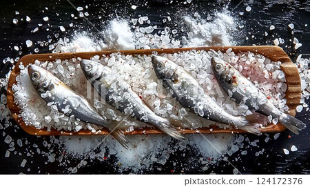 Fresh Anchovies on Wooden Tray with Sea Salt and Spices Fresh Anchovies on Wooden Tray with Sea Salt and Spices 124172376
