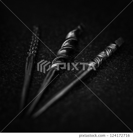 A Twisted Black Sculpture Set Against a Dark Background that Captivates the Viewer 124172716