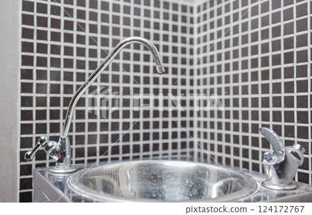 Stylish and Modern Sink with a Contemporary Faucet Set in a Beautiful Mosaic Tile Setting Stylish and Modern Sink with a Contemporary Faucet Set in a Beautiful Mosaic Tile Setting 124172767