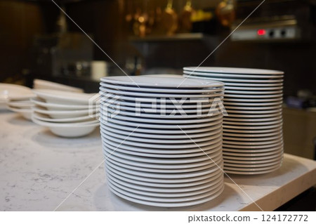 Beautifully Stacked Plates Arranged in a Contemporary Modern Kitchen Environment Setting 124172772