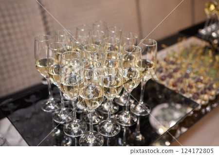 lot of glasses with champagne during on the party table lot of glasses with champagne during on the party table 124172805