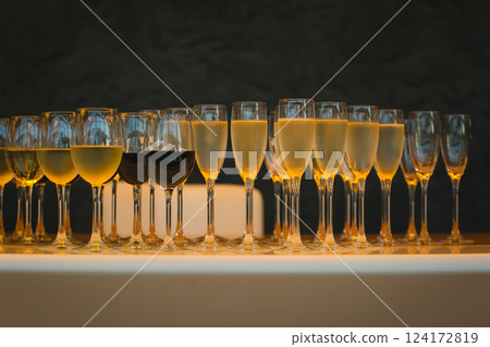 lot of glasses with champagne during on the party table lot of glasses with champagne during on the party table 124172819