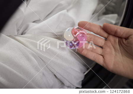 Using Laundry Detergent Pods While Doing Laundry in the Washing Machine with Clothes Using Laundry Detergent Pods While Doing Laundry in the Washing Machine with Clothes 124172868