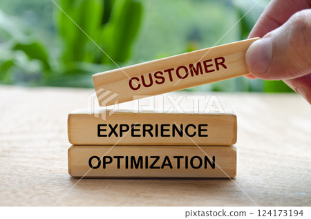 Customer Experience Optimization text on wooden blocks. Customer retention concept Customer Experience Optimization text on wooden blocks. Customer retention concept 124173194