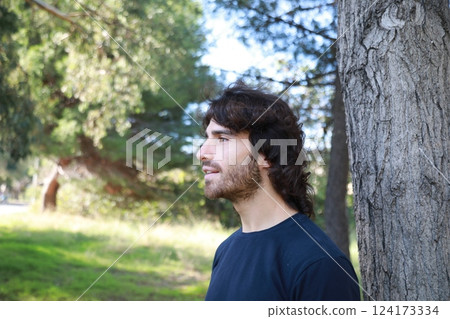 Young Long Hair Man Marveled In Nature Near A Tree 124173334
