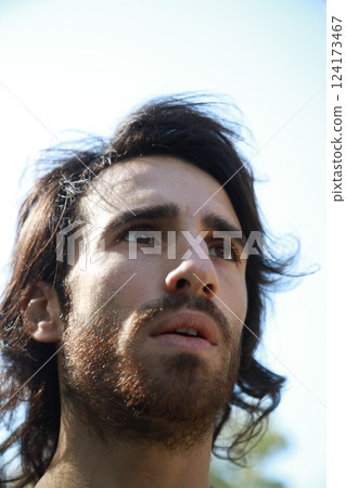 Italian Man with Long Hair Breathes Concentrated Pure Air in the Mountains Italian Man with Long Hair Breathes Concentrated Pure Air in the Mountains 124173467