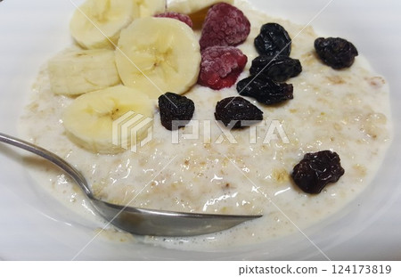 Morning porridge with fruits in white plate 124173819