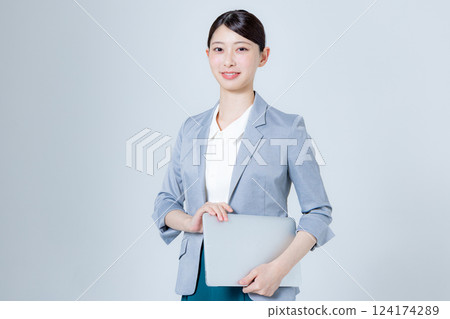 A female business person giving directions with a laptop 124174289