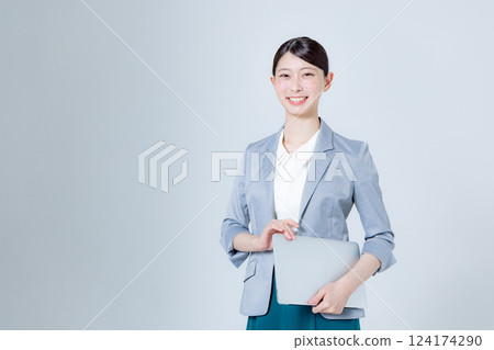 A female business person giving directions with a laptop 124174290