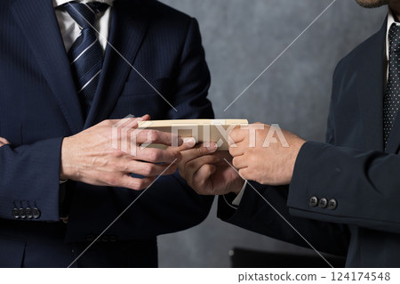 Image of giving a bribe such as a gift certificate 124174548