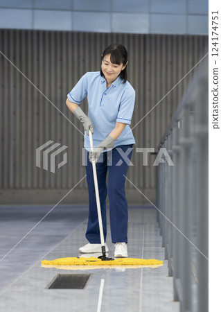 Image of building cleaning: Middle-aged female cleaning staff mopping the floor 124174751