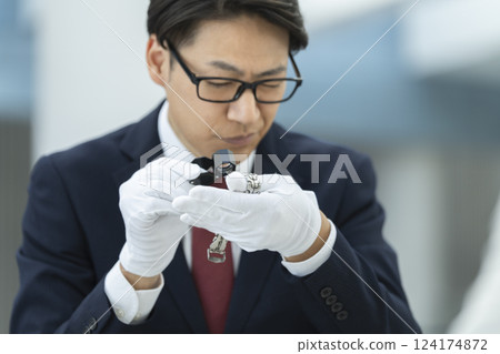 Image of an appraiser's hand appraising a wristwatch 124174872