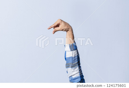 Hand gesturing the letter Q in sign language on an isolated background. Man's hand gesturing the letter Q of the alphabet isolated. Letter Q of the alphabet in sign language 124175601