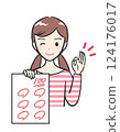 A smiling elementary school girl shows off the test she got 100 points on 124176017
