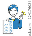 A boy in elementary school smiles and shows a test he got 100 points on (simple) 124176024