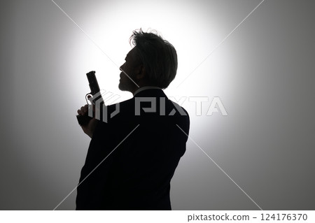 Man holding a gun 124176370