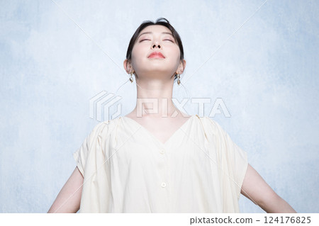 A beautiful young woman taking a deep breath with her hands outstretched - an image of stress-free A beautiful young woman taking a deep breath with her hands outstretched - an image of stress-free 124176825