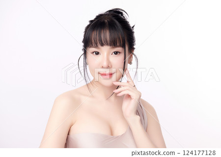 A beautiful young Asian woman with clean, fresh skin against a white background. Skincare, facial treatment, cosmetology, beauty, and spa. An elegant portrait of an Asian woman. A beautiful young Asian woman with clean, fresh skin against a white background. Skincare, facial treatment, cosmetology, beauty, and spa. An elegant portrait of an Asian woman. 124177128