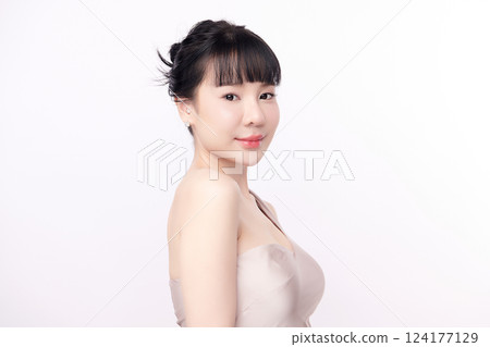 A beautiful young Asian woman with clean, fresh skin against a white background. Skincare, facial treatment, cosmetology, beauty, and spa. An elegant portrait of an Asian woman. A beautiful young Asian woman with clean, fresh skin against a white background. Skincare, facial treatment, cosmetology, beauty, and spa. An elegant portrait of an Asian woman. 124177129