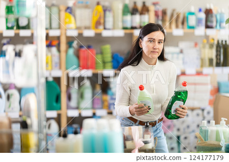 Female buyer choosing dishwashing detergents 124177179
