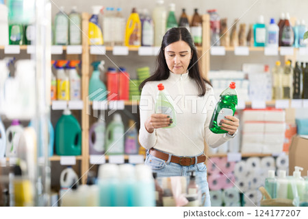 Female buyer choosing dishwashing detergents 124177207