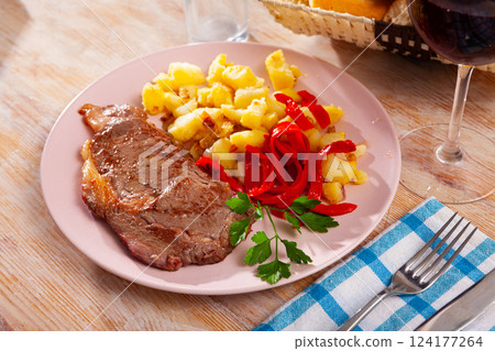 Tasty veal baked with potatoes and peppers served at plate 124177264