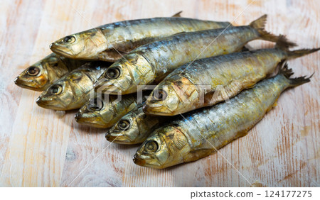 Salted and pressed sardines on wooden table Salted and pressed sardines on wooden table 124177275